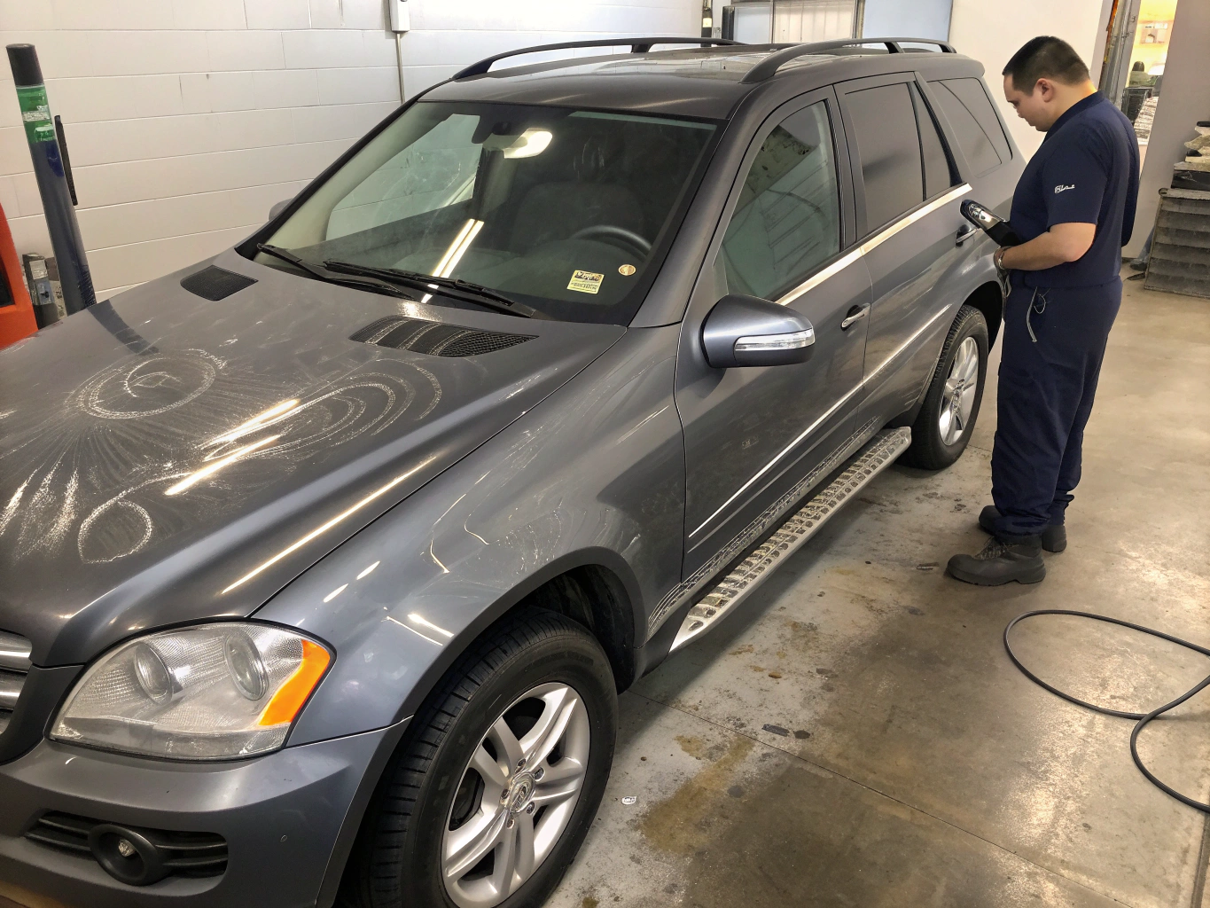 Professional automotive detailing work performed at Raven Automotive studio - LED inspection light over metallic flake paint